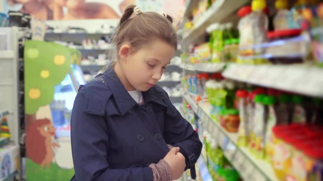 portrait of teenage girl stealing groceries in a big store