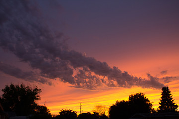 Fototapeta na wymiar dramatic sunset over nampa idaho with cloud shaped like a dragon
