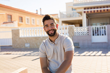 Fototapeta premium young man sitting smiling outdoor