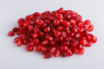 grains of a grenade on a white acrylic background