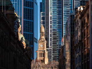 Closeup of an old building in the middle of tall business buildings in downtown Sydney
