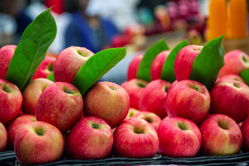 Red Apple and leaves placed in piles