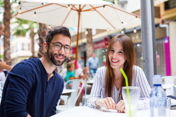 two friends smiling in the bar
