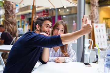 two friends taking a photo in the bar