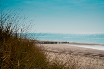 Fototapeta na wymiar breakwater on the beach, dunes of Burgh Haamstede, The Netherlands. North Sea coast