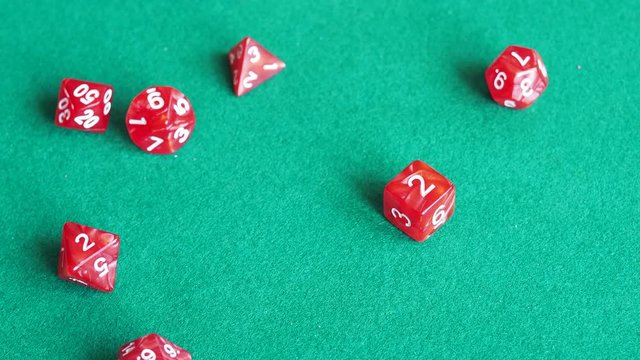 player throws many red polyhedral dices on green board