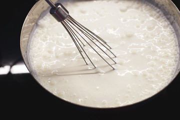 cream is whipped with a mixer in a bowl