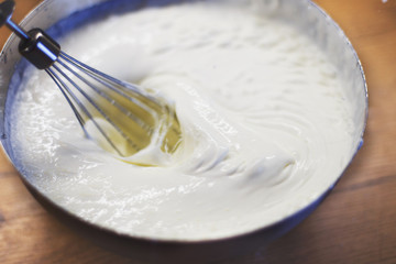 cream is whipped with a mixer in a bowl