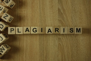 Plagiarism word from wooden blocks on desk