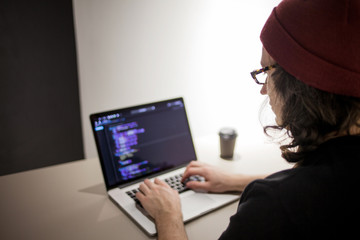 Programmer and coder working in the development environment. Programmer's workplace