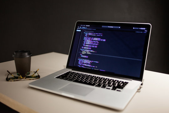 Programmer's workplace, laptop with project code. Development of websites and applications