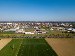 Aerial drone view of Haunstetten, a suburb of Augsburg in Germany. View over the federal Highway B17 towards the commercial and industrial district of Haunstetten.