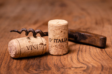 in the foreground, corks of Italian wine, and vintage corkscrews