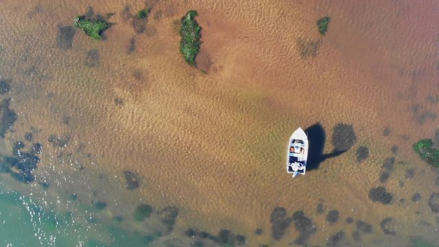 Aerial view of fisherman casting from a boat to catch fish