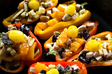 Sweet pepper stuffed with vegetables and mushrooms. Seasonal vegetable dish.