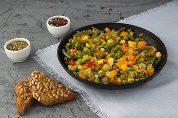 Cooked chopped vegetables in a boiling pan with spices. Vegan food.