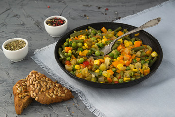 Cooked chopped vegetables in a boiling pan with spices. Vegan food.