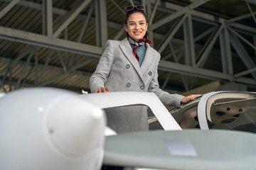 Smiling Young Business Woman Boarding Private Plane