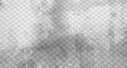 shadow of cage at old cement wall