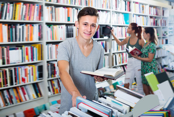 Portrait of positive boy looking at open book