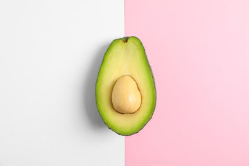 Rip cut avocado on two tone background, space for text
