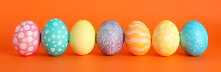 Decorated Easter eggs on color background. Space for text