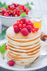 Homemade Pancakes with fresh red berries and honey