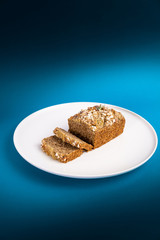Almond bread loaf with Almond diced and Banana sliced set on Blue Background.