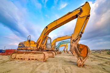 Large excavator under the blue sky white clouds