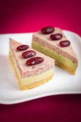 Sliced of Red bean cheese cake on white plate on red Background.