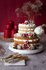 White cake Decorated with flower and berries. For celebrate party weddings, birthdays and events.