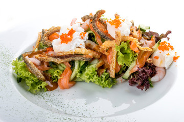 Salad with salmon belly, shrimp and poached egg. On white background