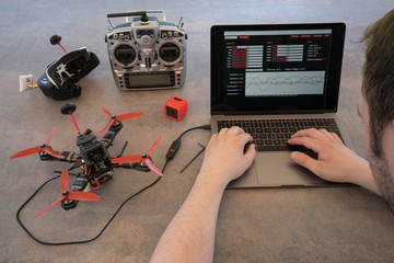 fine tuning a racing drone on a computer.