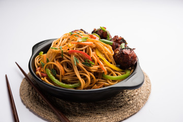 Manchurian Hakka / Schezwan noodles, popular indochinese food served in a bowl. selective focus