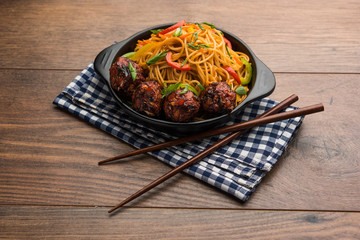 Manchurian Hakka / Schezwan noodles, popular indochinese food served in a bowl. selective focus