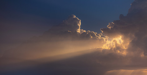 Great panorama of beautiful early morning sunlight through fluffy huge white clouds at sunrise time. Horizontal color photography.