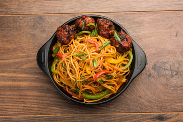 Manchurian Hakka / Schezwan noodles, popular indochinese food served in a bowl. selective focus