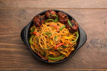 Manchurian Hakka / Schezwan noodles, popular indochinese food served in a bowl. selective focus