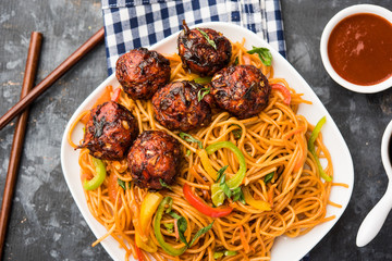 Manchurian Hakka / Schezwan noodles, popular indochinese food served in a bowl. selective focus