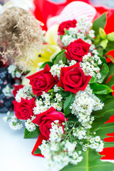 Valentines day background. Beautiful bouquet of roses on wooden table . Luxury bouquet made of red roses in flower shop Valentines Bouquet of red roses.  Rose bouquet. Soft focus of a Rose .