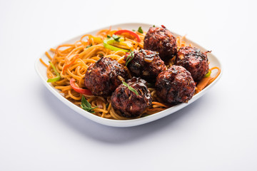 Manchurian Hakka / Schezwan noodles, popular indochinese food served in a bowl. selective focus