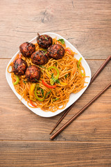 Manchurian Hakka / Schezwan noodles, popular indochinese food served in a bowl. selective focus