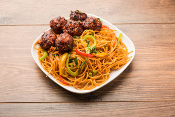 Manchurian Hakka / Schezwan noodles, popular indochinese food served in a bowl. selective focus