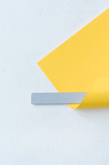 gray nail file wrapped in yellow paper