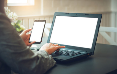 Closeup young asian woman using smartphone and laptop working and searching for data