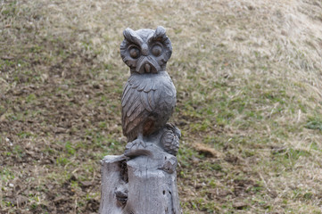 Owl carved from wood on a hiking path in val gardena