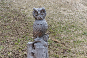 Owl carved from wood on a hiking path in val gardena