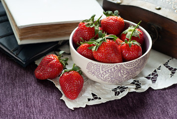 Fragrant strawberry in a purple bowl