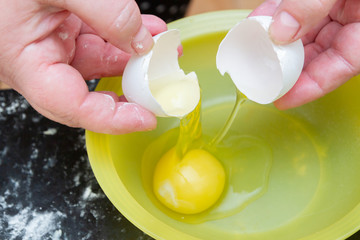 Chicken egg was broken into a plastic plate for cooking