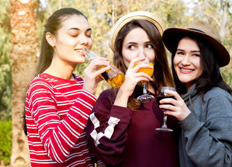 Young womans with alcohol on the garden. Picnic concept.
